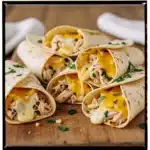 Ooey-Gooey Cheesy Garlic Chicken Wraps 3 Cheesy garlic chicken wraps with melted cheese and fresh ingredients