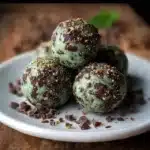 Mint Chocolate Chip Protein Balls – 10 Irresistible, Healthy Snacks You'll Crave 3 Mint chocolate chip protein balls on a wooden table