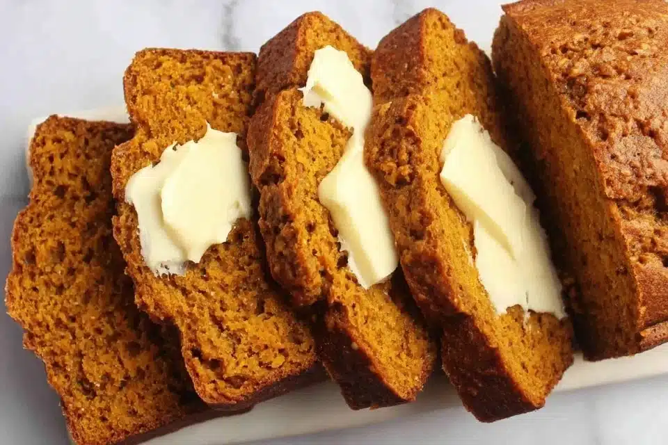 Moist butternut squash bread with fall spices on a wooden table