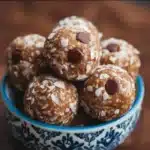 No-Bake Protein Balls: 7 Amazing Recipes for Healthy Snacking 3 Delicious homemade no-bake protein balls stacked on a plate