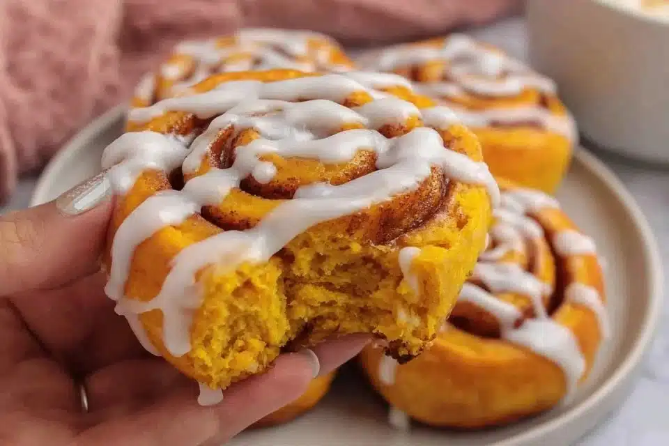 Delicious easy pumpkin cinnamon rolls without yeast, drizzled with icing.