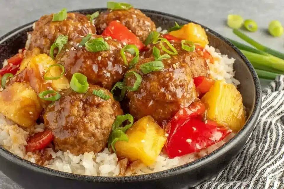 Easy Sweet and Sour Meatballs with Pineapple 4 Easy sweet and sour meatballs with pineapple served on a plate