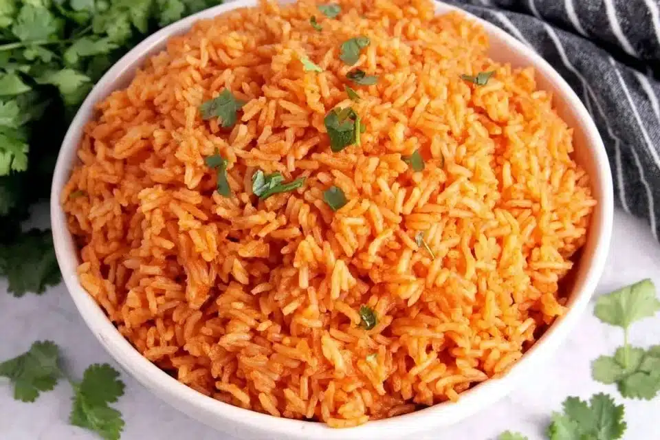 The Best Restaurant-Style Mexican Rice Recipe You’ll Love 4 Bowl of flavorful restaurant-style Mexican rice garnished with herbs