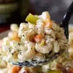 Delicious Dill Pickle Macaroni Salad served in a bowl with fresh herbs.