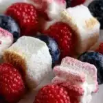 Festive patriotic fruit skewers with red, white, and blue fruits