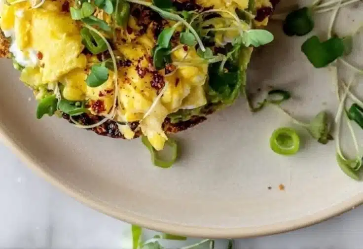 Crispy Hashbrown Avocado Toast Recipe 2 Crispy hashbrown avocado toast served on a plate with garnish